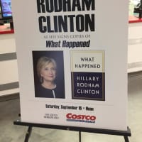 <p>A poster at Costco promotes the Saturday book-signing by Hillary Clinton at the Brookfield store.</p>
