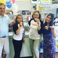 <p>Daisy Dreams co-owner Kathleen Ruane and her daughter Rose (center) are flanked by two members of the Suffern Chamber of Commerce during an ice cream social on Saturday afternoon.</p>