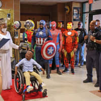 <p>Benjamin Brunson, a second grader at Rebecca M Johnson School, was gifted an accessibility tricycle from Bob &quot;The Bike Man&quot; Charland on Thursday, April 13. Local Police and firefighters dressed up as superheroes for the ceremony.</p>