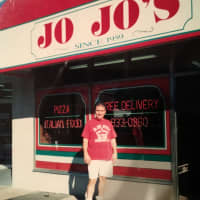 <p>Junior stands in front of JoJo&#x27;s in the earlier years, before changing the storefront.</p>