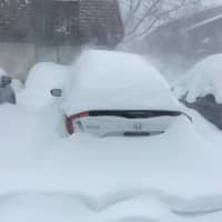 <p>Cars are already buried in Poughkeepsie in a photo taken at noontime.</p>