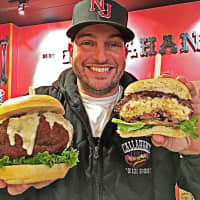 <p>Dan DeMiglio holds the gouda mac and cheese truffle burgers sold exclusively at Callahan&#x27;s in Norwood.</p>