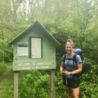 <p>Kristen Geary, a Fairfield resident who is hiking the Appalachian Trail from Georgia to Maine this spring, arrives in Connecticut on Wednesday. The sign along the trail says &quot;Gateway to New England.&quot;</p>