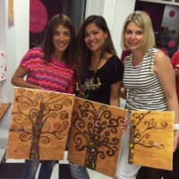 <p>Eve Klein, Christine Capizzi and Jen Prins show off their work.</p>