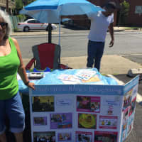 <p>Ulanda White pictured alongside the Haverstraw King&#x27;s Daughter Library stand at the Haverstraw Farmers&#x27; Market.</p>