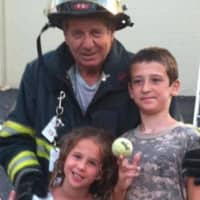 <p>Park Ridge Firefighter Mario Izzo with two of his grandchildren, Mia and Timothy Izzo.</p>