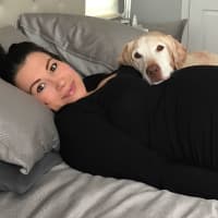 <p>Max lays on a pregnant Jessica Galarza.</p>