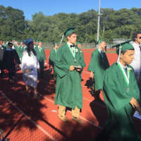 <p>The members of the Class of 2016 stream onto the track for the Norwalk High graduation.</p>