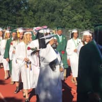 <p>The Class of 2016 at Norwalk High moves onto the football field for the commencement exercises.</p>