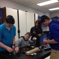 <p>Moriah School of Englewood students and science teacher Sandra Knoll prepare for the Maker Xpo.</p>