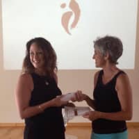 <p>Program and Marketing Director for Garfield YMCA Marisa Barcia (left) receives her certified white belt for teaching NIA from instructor Helen Terry (right).</p>