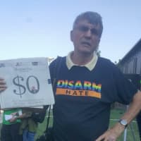 <p>Bruce McFadden of Monroe joins the protest outside the planned Donald Trump rally Saturday at Sacred Heart University.</p>