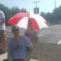 <p>An umbrella provides some needed shade in the line for the Trump rally at SHU.</p>