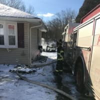 <p>Danbury firefighters battle a shed fire at 12 Jackson Drive on Friday.</p>