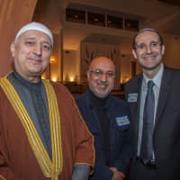 <p>Imam Moutaz Charaf, left, with Rabbi Noah Fabricant, far right, and a participant of the Temple Beth Or Interfaith Service.</p>