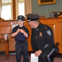 <p>Jack gets sworn in as police chief in the council chambers.</p>