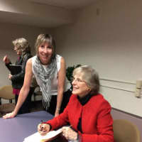 <p>Financial author Jane Bryant Quinn prepares to sign a book for a fan at the event Sunday at the Danbury Public Library that was organized by Maryellen DeJong, community relations director at the library.</p>