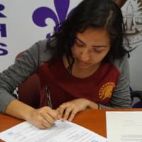 <p>Student-athlete Jennyfer Huerta signs a letter of intent to attend St. Thomas Aquinas College this fall.</p>