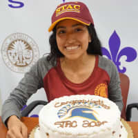 <p>New Rochelle student-athlete Jennyfer Huerta celebrates with a cake after signing a letter of intent to attend St. Thomas Aquinas College this fall.</p>
