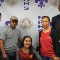 <p>New Rochelle student-athlete Jennyfer Huerta is surrounded by her parents during the signing ceremony this week. At far right, is coach Andy Capellan. At far left is Steve Young, the district’s director of athletics.</p>