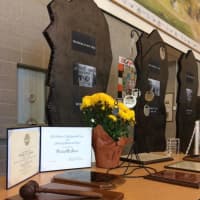 <p>A display at Shelton Intermediate School shows off a variety of awards given to Philip H. Jones Jr. He was known for his Christmas tree farm, for his support for the local library and for his collection of ephemera. He is featured on the ornaments. </p>