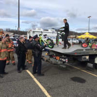 <p>Brookfield Police Department members, among volunteers, load a flatbed truck for delivery of toys to a children&#x27;s hospital.</p>