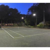 <p>A lighted tennis court is one of the amenities at the home at 54 Lower Shad Road in Pound Ridge.</p>