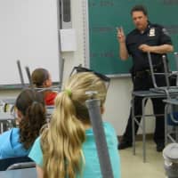 <p>Ken Ross, Chief of the Putnam County SPCA, talks to Girl Scouts about animal cruelty.</p>