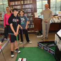 <p>Kids play a round of haunted mini-golf at the Warner Library.</p>