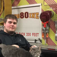 <p>A volunteer at Riverside Engine Co. No. 4 in Tarrytown holds a cat that wandered in one day and now doesn&#x27;t seem to want to leave.</p>