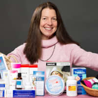 <p>Margot Malin, founder of Lots to Live For, with an array of products that help cancer patients with the side effects of chemo, radiation, and surgery.</p>