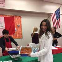 <p>Daniela Savone, teacher and president of the Italian Club, holds a tray of meatballs submitted for a contest and fundraiser at  North Rockland High School.</p>