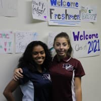 <p>Senior Ariana Panizzi (left) helped freshman Alexandra Waldman (right) ease into the Burke Catholic Family on the first day of school.</p>