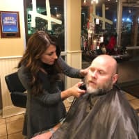 <p>H Salon co-owner Jackie Fernandes shaves Westport Police Officer Scott Morrison, winner of the Best Beard Award. Officers grew their beards to bring awareness to cancer research and the homeless in their community.</p>