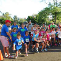<p>Kids burst from the starting line in the kids race at the All Out for Autism Friday in New Canaan.</p>