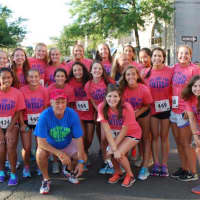 <p>Ron Rosenfeld, blue shirt, the race director and owner of New Balance New Canaan, meets runners.</p>