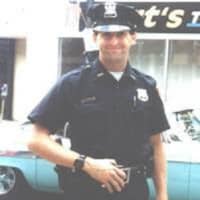 <p>Lt. Michael E. Neuner, shown walking the beat as a police officer in Peekskill, was a volunteer firefighter in Brewster. He died in 1997 in the line of duty while battling a house fire in the village.</p>