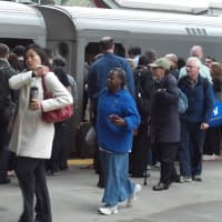 <p>Train riders jam the platform at the Stamford station on Monday morning.</p>