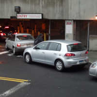 <p>Cars line up to enter the garage in downtown Stamford by the train station. It was filling up by 7 a.m., with only roof parking left.</p>