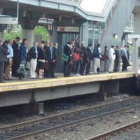 <p>Commuters line up to board a train in Stamford, where trains are running on a normal schedule. </p>