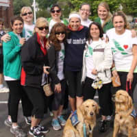 <p>Jenn Marr (Got Comfort shirt) stands with people in Saturday&#x27;s race and comfort dogs Addie and Maggie.</p>