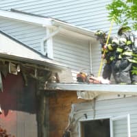 <p>Norwalk firefighters extinguish a blaze at 43 East Ave. in Norwalk Tuesday. No injuries were reported.</p>