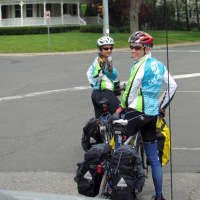 <p>Staples graduate Alec Bernard and friend Allie Wills make their way through Westport last Friday during the first day of their approximately 43 day cross country bike tour.</p>