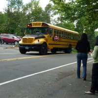 <p>Westport resident Betty Tsang (back right) uses the &quot;Where&#x27;s Our School Bus?&quot; app on her iPhone Monday afternoon to confirm the arrival of her daughter&#x27;s bus, alerting parents nearby that the bus is on its way.</p>
