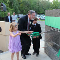 <p>Dr. Elliot Spiegel cuts the ribbon on the stone re-naming the Solomon Schechter School in his name.</p>