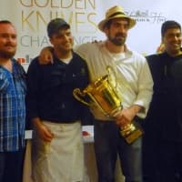 <p>Chef Carl Van Dekker, second from right, takes photos with his fellow competitors after winning the Golden Knives Challenge.</p>