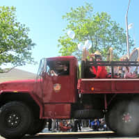 <p>Kids wave from a giant truck from the fire department. </p>