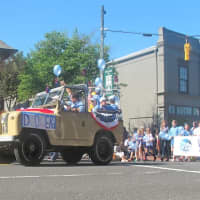 <p>A brightly colored jeep leads soccer players along the parade route. </p>