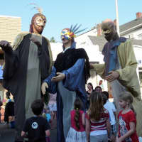 <p>Large papier-mache figures entertain party-goers on Main Street in Westport Thursday night during the third annual Art About Town street party.</p>