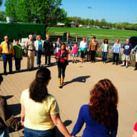 <p>Hilde Friderichs (center of circle) leads the first Circles of Peace event on Mother&#x27;s Day. </p>